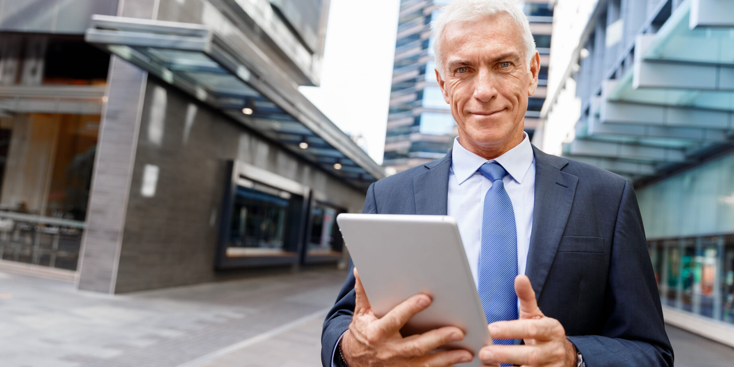 Senior businessman holding touchpad